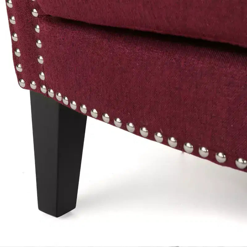 Fauteuil club contemporain en tissu Brice avec garniture cloutée